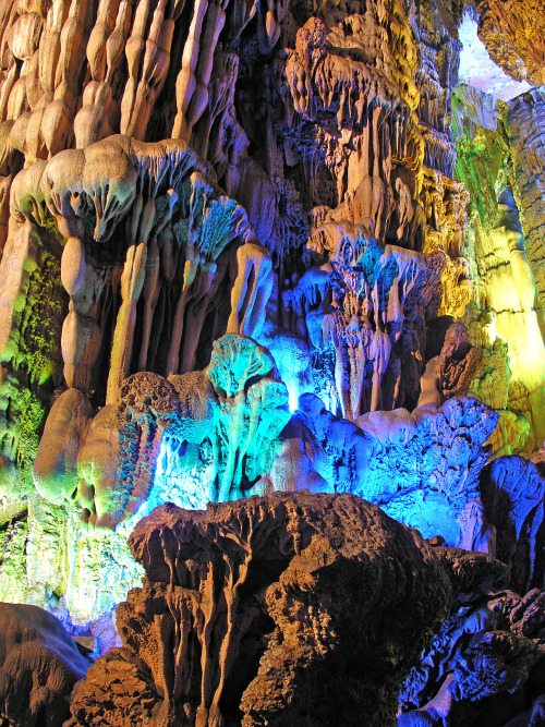 sixpenceee:    The Reed Flute Cave    The Reed Flute cave is a popular tourist attraction in Guilin, China. Inside this water-eroded cave is a spectacular world of various stalactites, stone pillars and rock formations created by carbonate deposition.