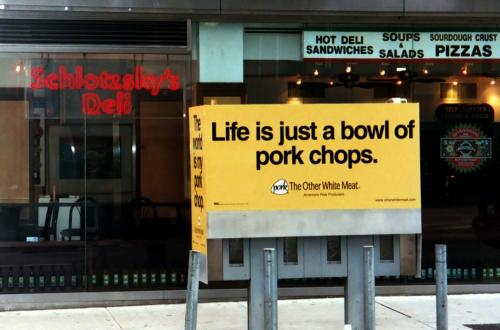 New York - Pork and Deli. Weird juxtaposition of an advertising sign and a famous deli, presumably k