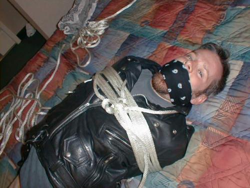 bubbabrando:  jhardcastle1976:  The best way to keep a guy in a leather biker jacket, tied up and his big mouth gagged  yes, it was quite effective. 