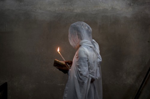 globalchristendom: An Ethiopian woman prays at Deir el-Sultan Monastery in the Church of the Holy Se