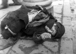 hateandheartache:  Warsaw, Poland, A Jewish boy dressed in rags, lying on the pavement in the ghetto, May 1941. From Yad Vashem. 