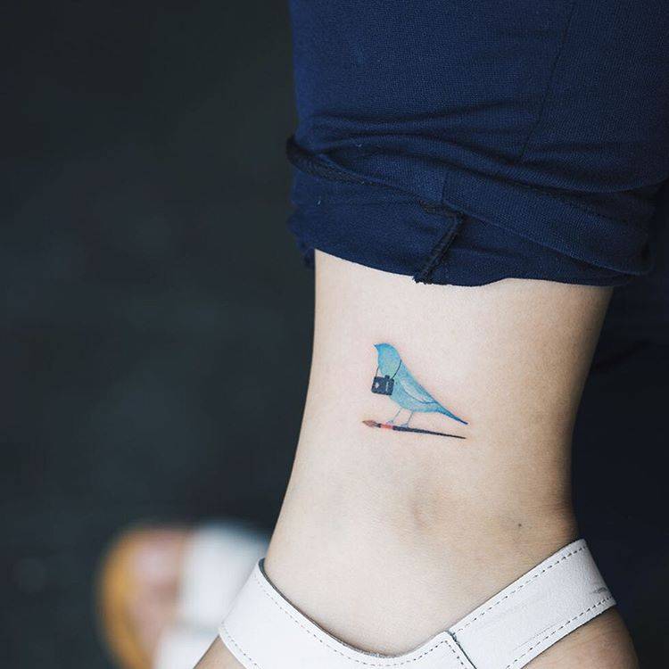 Blue swallow tattoo