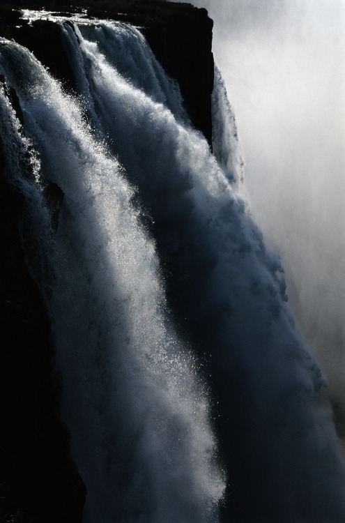 A twilight view of Victoria Falls on the Zambezi River in Zambia, 1996.Photograph by Chris Johns, Na