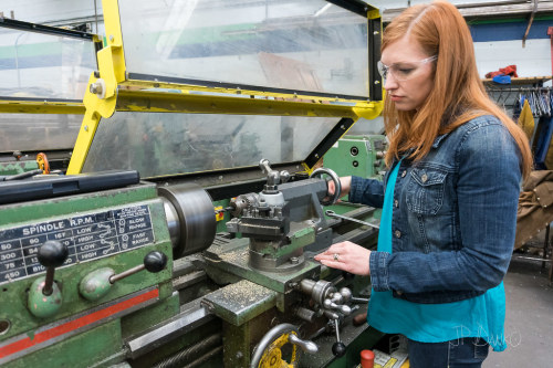 Female company executive tries out lathe in machine shop by blurMEDIA Photography Pretty reheaded wo
