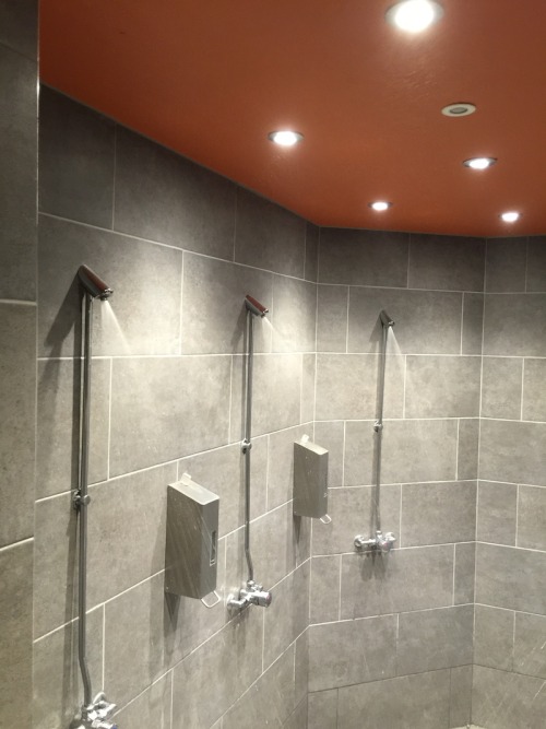 Men’s shower room at Bikram Yoga, Canary Wharf, London, UK.These showers were renovated in 2018. It’