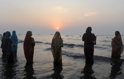 o-g-steve:awkwardsituationist:indian hindu devotees offer prayers to the sun in the arabian sea duri