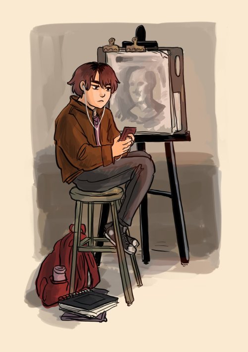 back to the drawing board[ID: kid with brown hair and jacket sitting on a stool in front of an art e