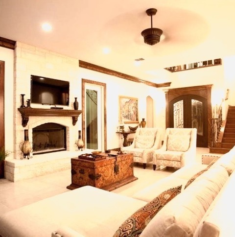 Austin Family RoomWith White Walls, A Wall-mounted Tv, A Bar, A Ribbon Fireplace, And A Brick Fireplace,