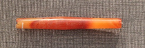 Red carnelian bead found at Ur(Sumer) from the reign of Shulgi (2094 – 2047 BC).This 7cm-long bead b