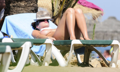 toplessbeachcelebs:  Lucy Pinder (British Model) sunbathing topless on the beach (December 2010)