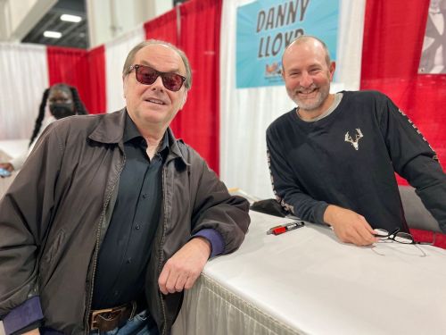 Dan Lloyd, who played Danny Torrance in The Shining, poses with a Jack Nicholson impersonator at the Motor City Comicon in October of 2021.