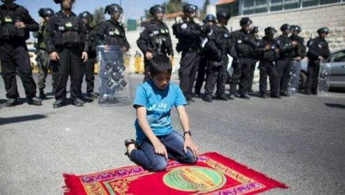 don-moh: A Palestinian boy defies the Israeli forces on friday after they prevented him from praying