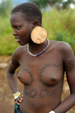 By Christophe Cerisier.  Mursi girl with large wooden earrings