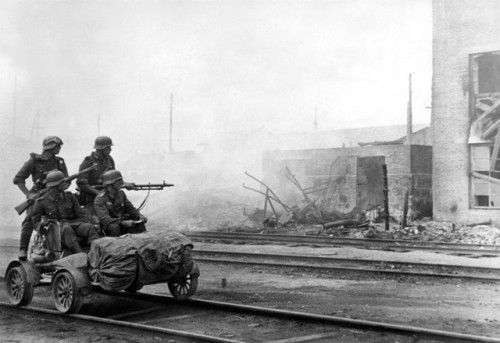bag-of-dirt:German Wehrmacht troops of the 11th Army use a rail handcar to move through the ruined s