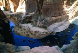 unrar:  Camels drink from one of the few permanent water holes on the edge of the Ennedi Plateau, Chad, George Steinmetz.