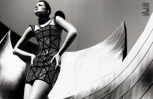 Eniko Mihalik poses at the Guggenheim Museum Bilbao (1997), Bilbao, Spain, designed by Frank Ge