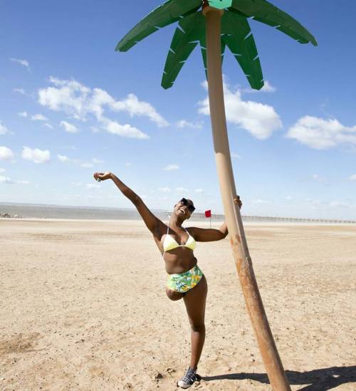 interdevo: Mama Cax is posing in bikini and converse shoe, standing on crutches on cold winter beach