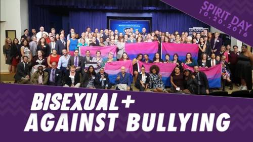 [ Image: Group photo of some of the Bisexual+ Advocates, some holding Bi Pride Flags who gathered at