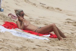 toplessbeachcelebs:  Laeticia Hallyday (Model) sunbathing topless on the beach (August 2009) 