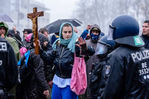 Berlin, GermanyA woman with a large cross gestures to police during a protest against planned new re