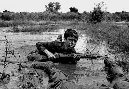 enrique262:historicaltimes:Child soldier in an oil drenched swamp during the Iran-Iraq War. Probably