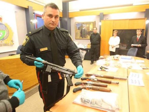 diyselfdefense: A submachine-gun and a half dozen sawed off shotguns seized during a gang house raid