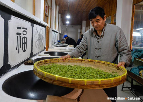 Ancient Making Technique Of Chinese Tea BiluochunYan Jielong dries baked Biluochun tea in Dongshan t