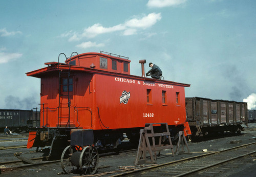 Finishing touches to a rebuilt Chicago and North Western Railway caboose at the Proviso Freight Yard