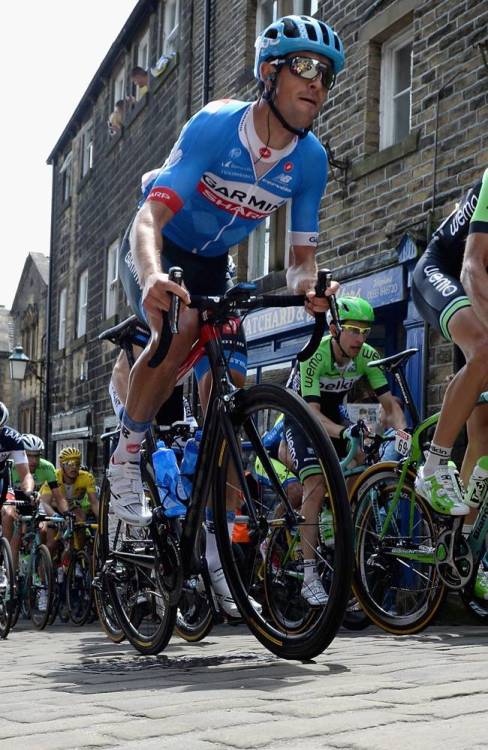 fuckyeahcycling: HAWORTH, ENGLAND - JULY 06: The Peloton ride along the cobbles on Haworth Main Str