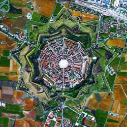 dailyoverview:The town of Palmanova, Italy is recognized by its concentric layout known as a “star fort.” The rationale for this construction was that an attack on any individual wall could be defended from the two adjacent star points by shooting