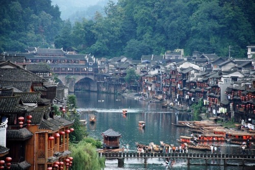 odditiesoflife:  The Ancient Town of Fenghuang, China The town of Fenghuang is located in the Hunan province in China along the banks of the Tuo Jiang River. The town is exceptionally well-preserved and relatively untouched by modern urbanization. The