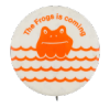 a white pin with orange text that reads 'The Frogs is coming'. an orange frog is seen popping its head out of the water