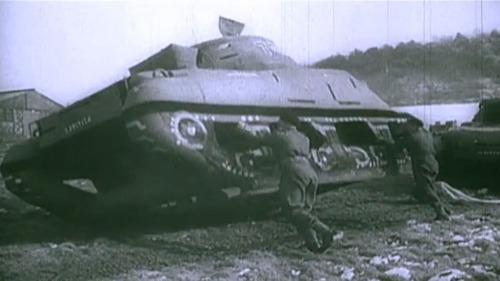 Soldiers play with an inflatable tank, one of the many decoys that allied armies used to disguise th