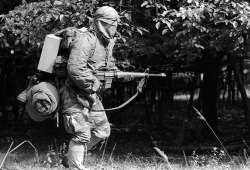 they-drift-like-worried-fire:  A1C Donald Miller, 363rd Security Police Squadron, dressed in protective gear and, carrying an M-16 rifle, changes his position during exercise Reforger ‘80.