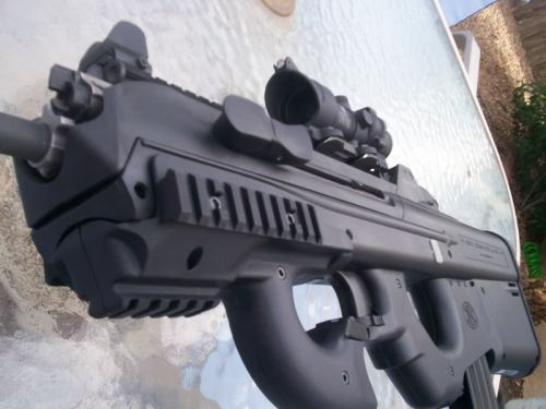 gunrunnerhell:  Hybrid Sometimes you’ll see photos of the FS2000 with an odd looking forward grip. These were aftermarket parts sold by Monolith Arms that combined the FN P90’s forward thumbhole grip into the FS2000. It replaces the rather wide stock
