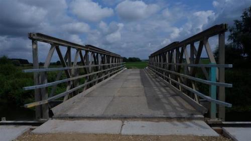 Into the Distance.A bridge over the River Derwent at Wheldrake Ings, North Yorkshire. England.