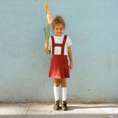 Little girl in Havana, Cuba with a Gladiolus 