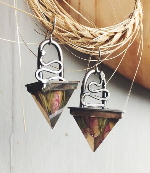 also in the shop now are these serpent and rose earrings. real roses frozen in resin pyramids with s