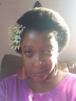 sophiaslittleblog:I love sticking flowers in my afro puff. I dont take a lot of selfies because I’m very self conscious, but this has to be my favorite photo of myself. My black is beautiful.