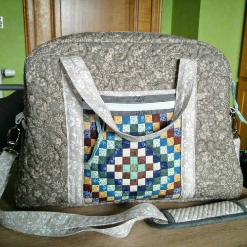 I made a bag and used my miniature quilt as front pocket Pattern is Ultimate Travel Bag from ByAnnie
