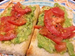 vegan-hannie:  A toasted white baguette topped with avocado and tomato, simply delicious.