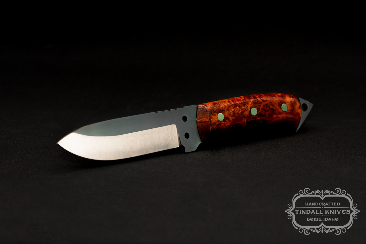 gunsknivesgear:  Tindall Knives. 01 tool steel blade. Amboyna burl handles with black