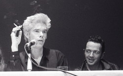 glipterodattilivolano:  Jim Jarmusch smoking at a NYFF press conference for Mystery Train in 1989, with Joe Strummer. Photo by Godlis. 