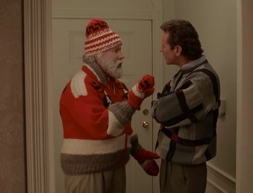 Santa Claus wearing what is arguably the most perfect sweater ever in his appearance in the great 90