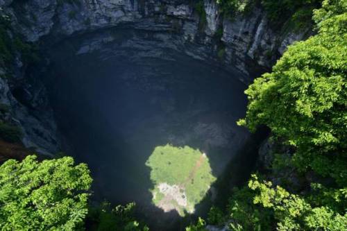 gorgeousgeology:This is a sinkhole in Hubei province, China. It’s 950 feet deep and home to its own 