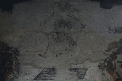 The fading remains of a medieval Giant skeleton painting dominates one wall of  St Lawrence Chu