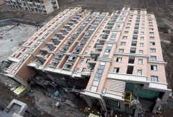 boyirl:  In the weekend of June 27/28 this new and uninhabited building tipped over in Shanghai. Unfortunately one worker got killed. The building itself is very well constructed, even most glass windows are intact.Picture by AP, 2009