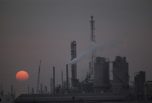 unrar:  A refinery set against a polluted sky at twilight, Taiwan, Jodi Cobb. 