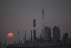 Unrar:  A Refinery Set Against A Polluted Sky At Twilight, Taiwan, Jodi Cobb. 