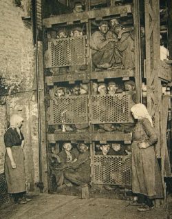 sixpenceee:  Belgium coal miners crammed into a coal mine elevator, coming up after a day of work, circa 1900. 
